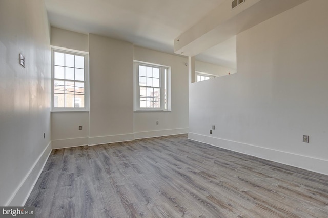 spare room with light hardwood / wood-style flooring