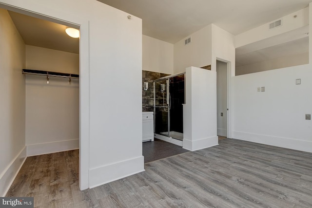 unfurnished bedroom featuring wood-type flooring and a closet