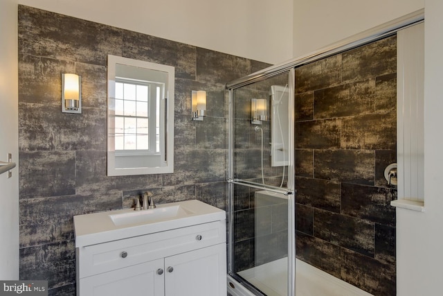 bathroom featuring walk in shower and vanity