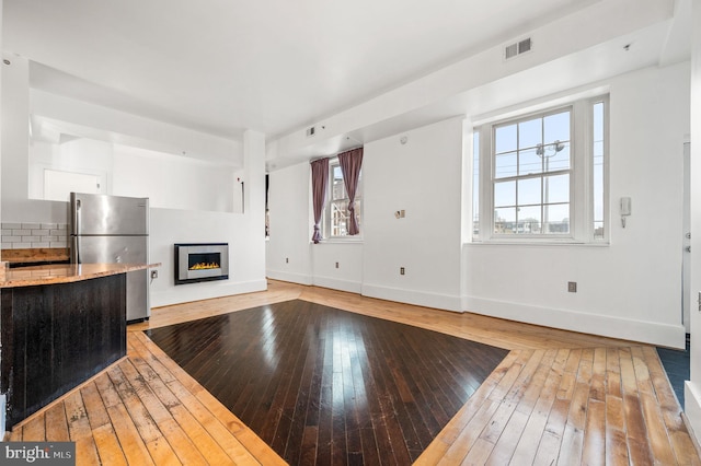 unfurnished living room with light hardwood / wood-style flooring