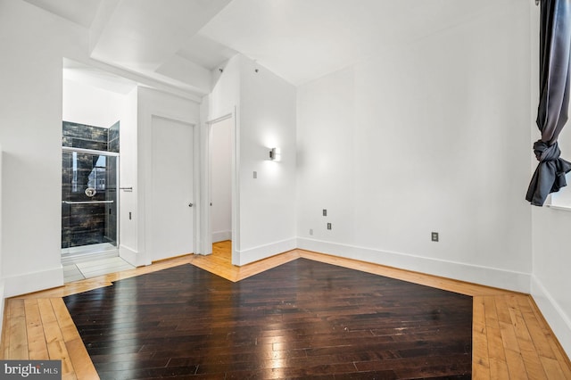 empty room with hardwood / wood-style floors