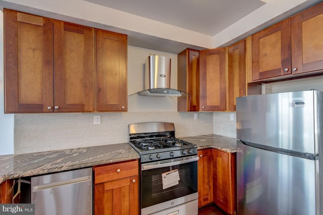 kitchen with light stone countertops, wall chimney range hood, backsplash, and stainless steel appliances