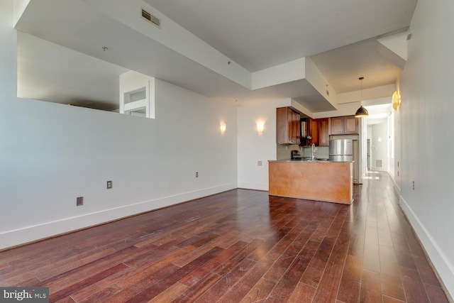 unfurnished living room featuring dark hardwood / wood-style floors