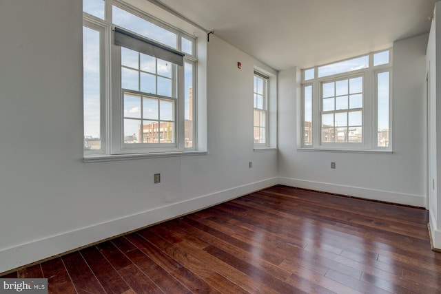 spare room with dark hardwood / wood-style flooring