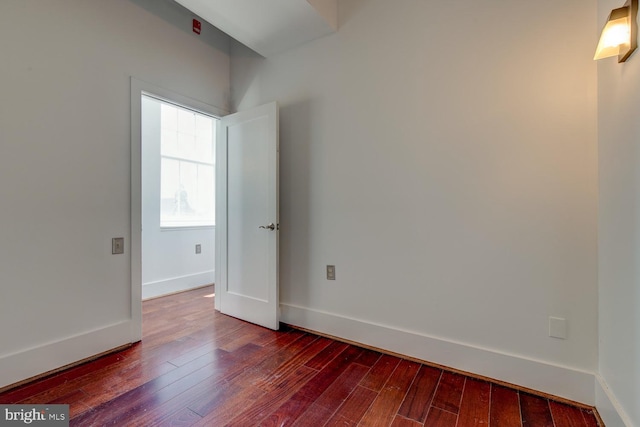 unfurnished room featuring dark hardwood / wood-style floors