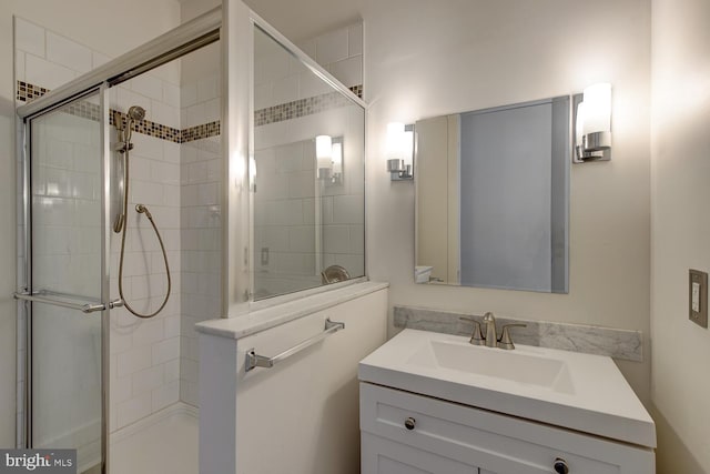 bathroom featuring vanity and a shower with door