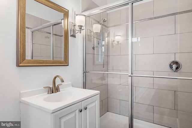 bathroom featuring vanity and a shower with door