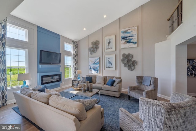 living room with high vaulted ceiling and hardwood / wood-style floors