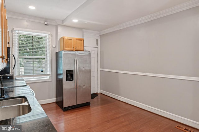 kitchen featuring crown molding, light brown cabinets, stainless steel fridge, and dark hardwood / wood-style flooring