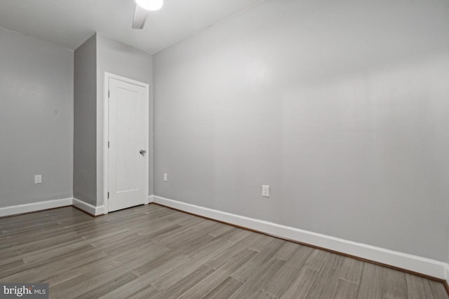 empty room featuring hardwood / wood-style floors and ceiling fan