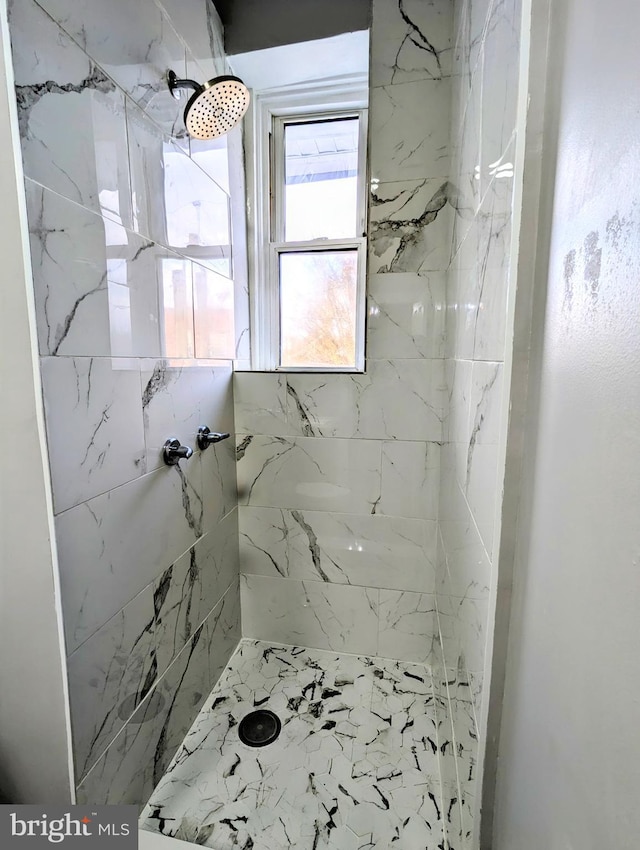 bathroom with a tile shower