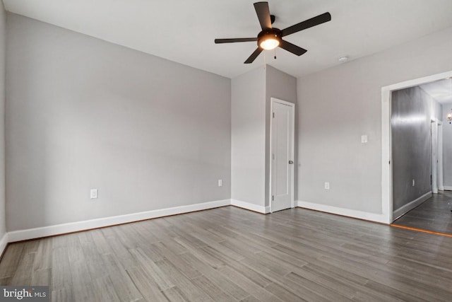 empty room featuring hardwood / wood-style floors and ceiling fan