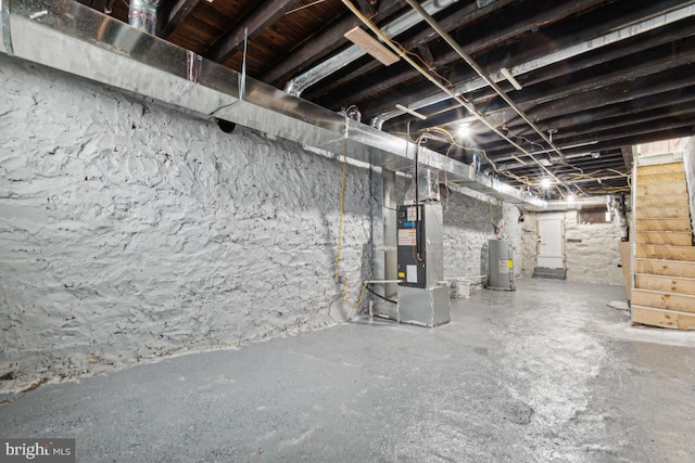 basement featuring water heater and heating unit