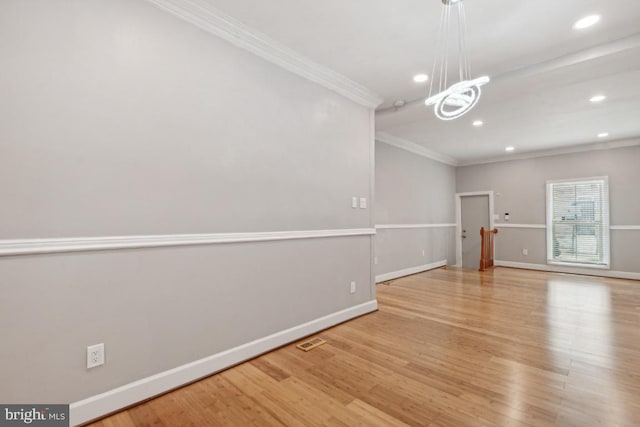 interior space featuring crown molding, light hardwood / wood-style flooring, and a chandelier