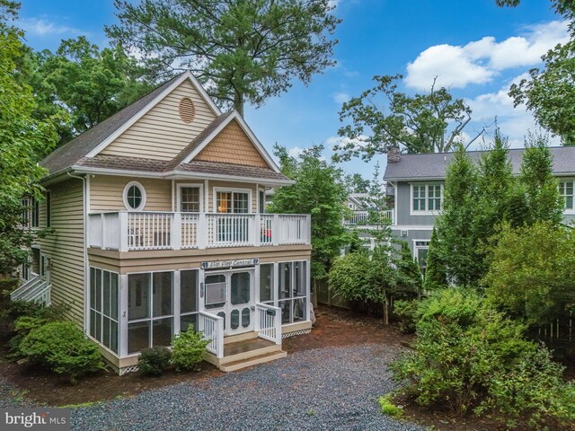 exterior space with a balcony and a sunroom