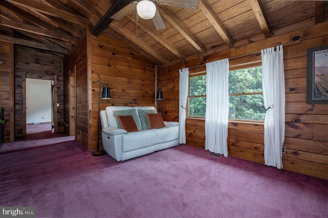 unfurnished room featuring wooden walls, wooden ceiling, ceiling fan, vaulted ceiling with beams, and carpet flooring