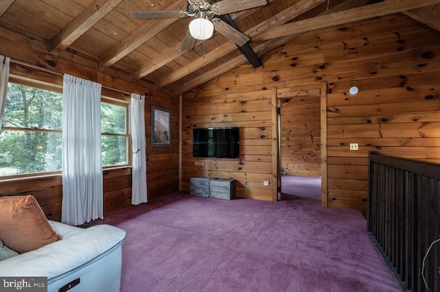 living area with ceiling fan, carpet, lofted ceiling with beams, wooden walls, and wooden ceiling