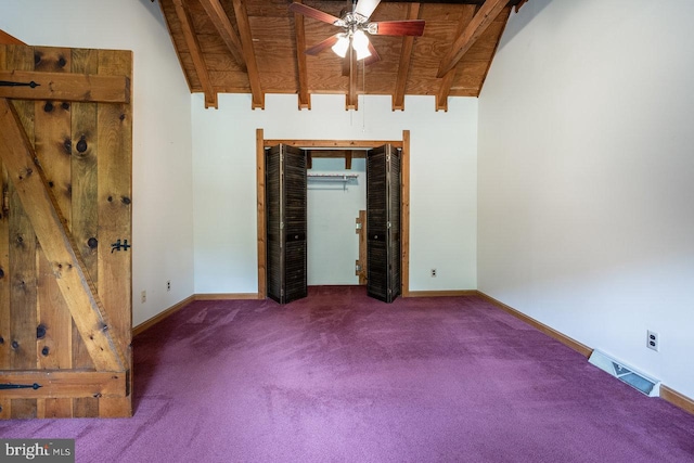 unfurnished bedroom with vaulted ceiling with beams, wood ceiling, and dark colored carpet