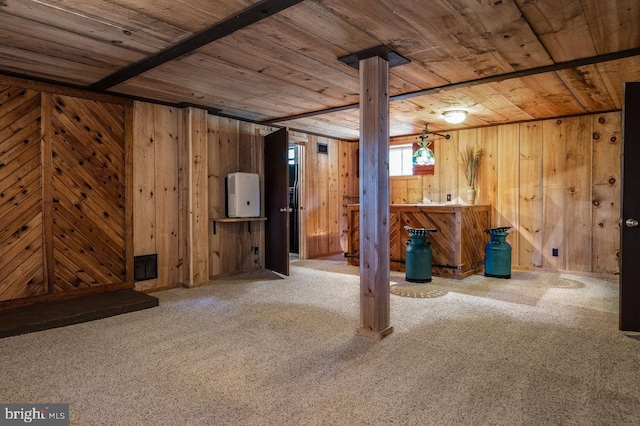 basement with carpet, wood ceiling, and wood walls