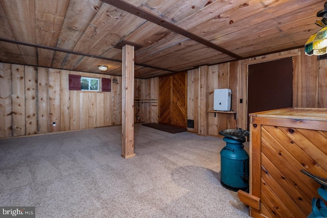 basement featuring carpet, wood walls, and wood ceiling