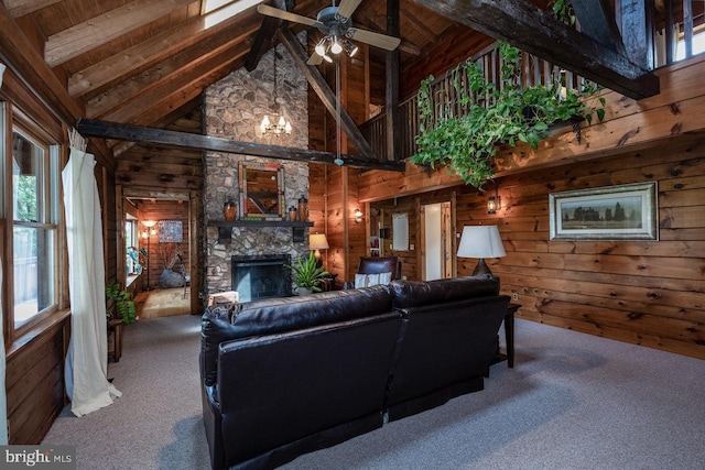 carpeted living room featuring beam ceiling, plenty of natural light, and wooden walls