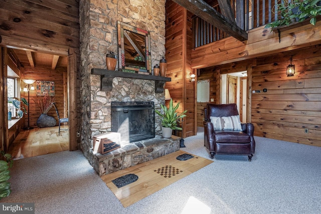 living room featuring carpet floors, beamed ceiling, and wooden walls