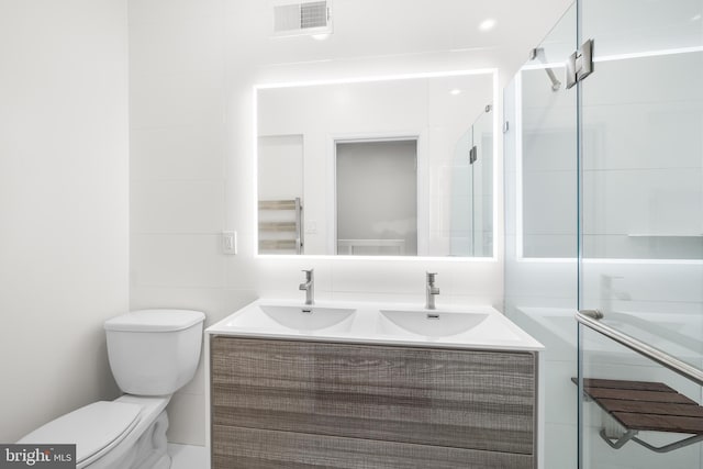 bathroom featuring tile walls, toilet, and vanity