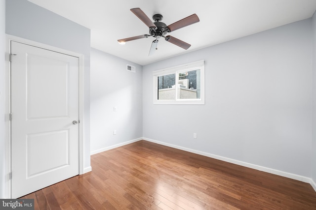 empty room featuring ceiling fan and wood-type flooring