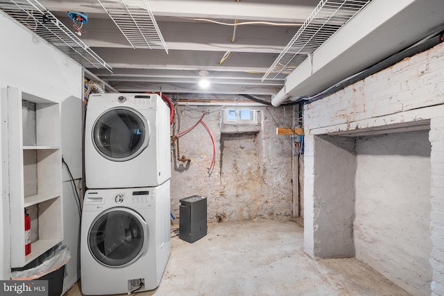 clothes washing area featuring stacked washer / dryer