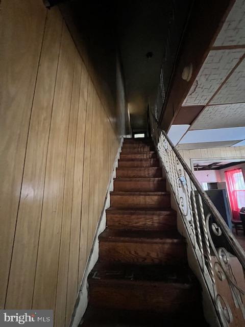 staircase with wooden walls