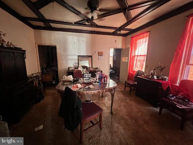 dining room featuring ceiling fan, beam ceiling, and coffered ceiling