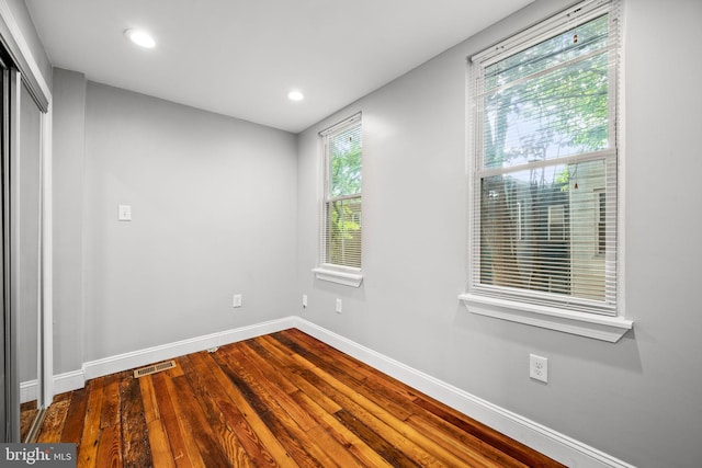 unfurnished room with hardwood / wood-style floors