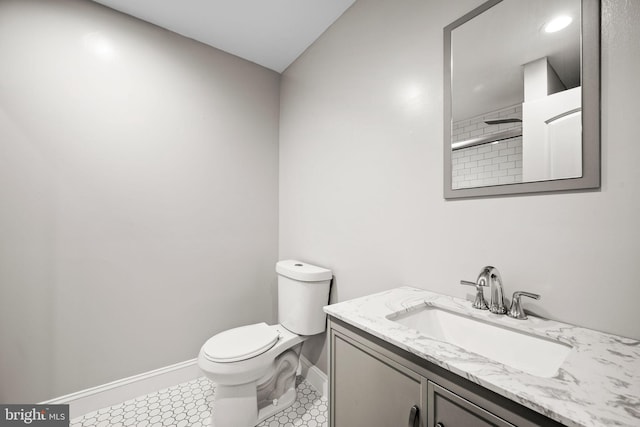 bathroom with toilet, vanity, a shower, and tile patterned floors