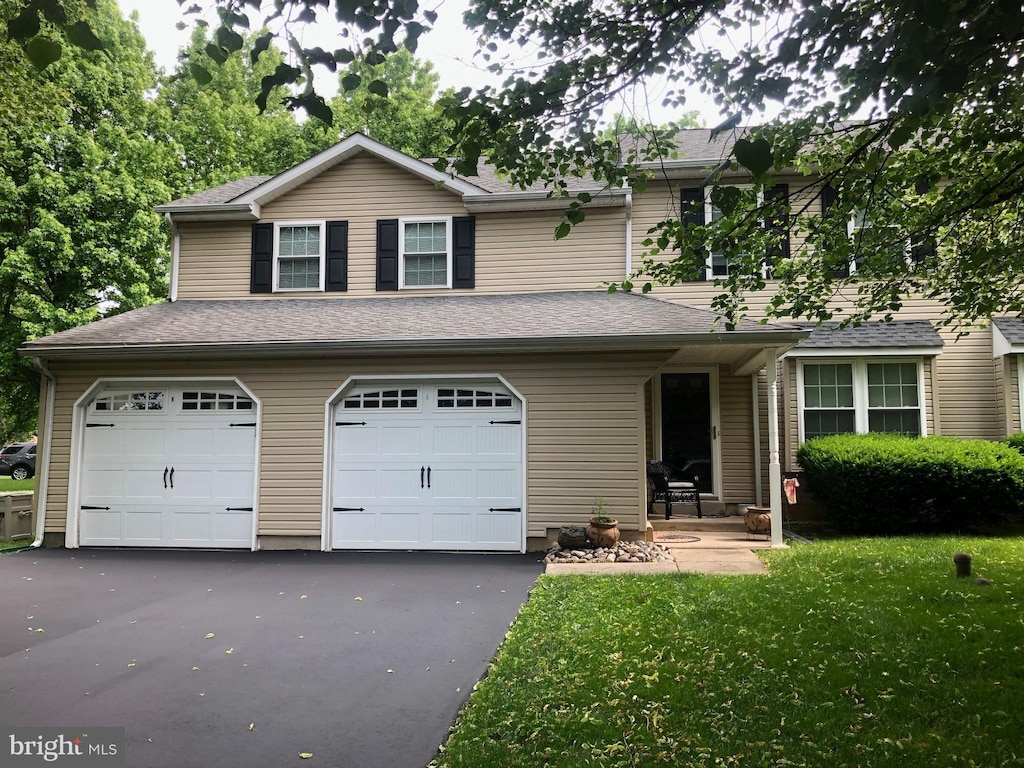 view of front of house with a garage and a front yard