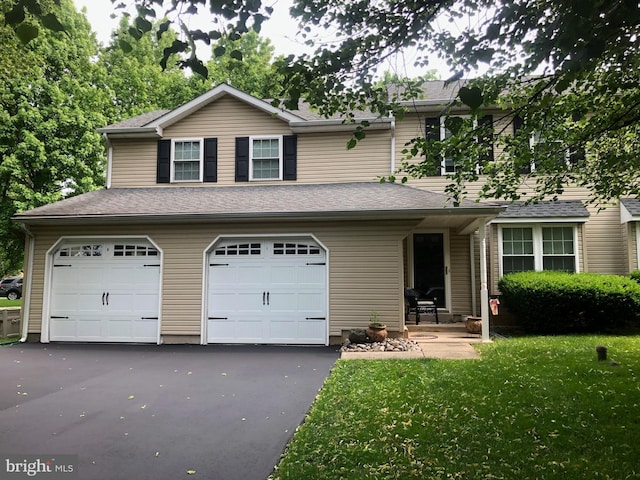 view of front of house with a garage and a front yard