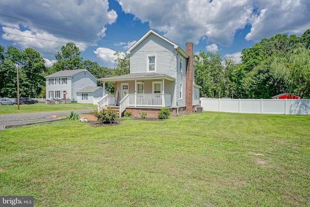 view of front of property with a front lawn and covered porch