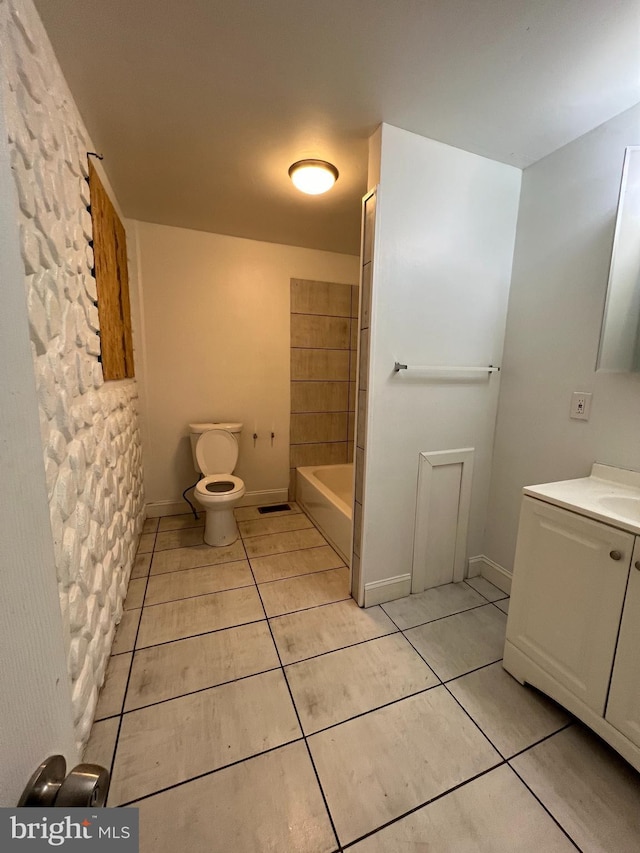 full bathroom featuring toilet, vanity, tile patterned flooring, and shower / tub combination