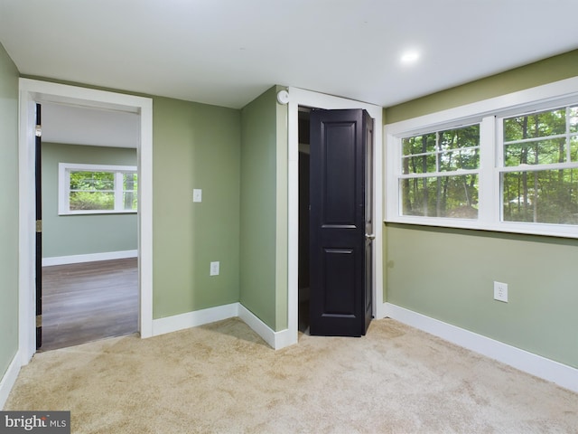 unfurnished bedroom with light colored carpet