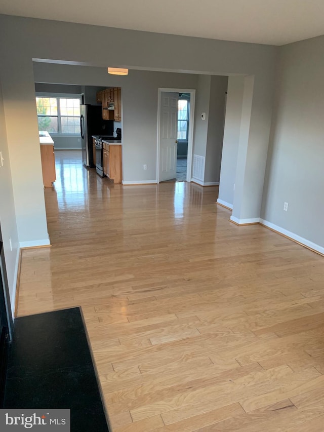 unfurnished living room featuring light wood-type flooring