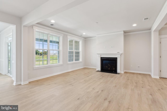 unfurnished living room with a premium fireplace, ornamental molding, and light hardwood / wood-style floors