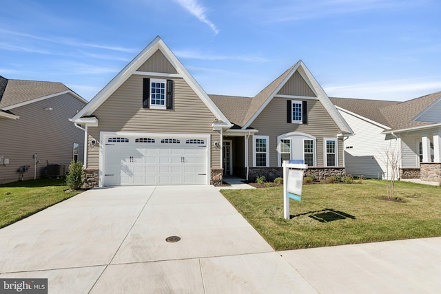 view of front of property with a front lawn, a garage, and central air condition unit