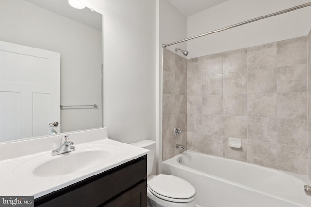 full bathroom with toilet, tiled shower / bath combo, and vanity