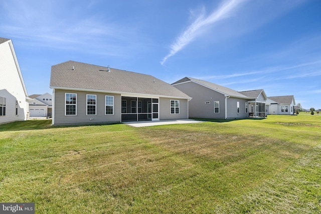 rear view of house featuring a patio area, a sunroom, and a lawn