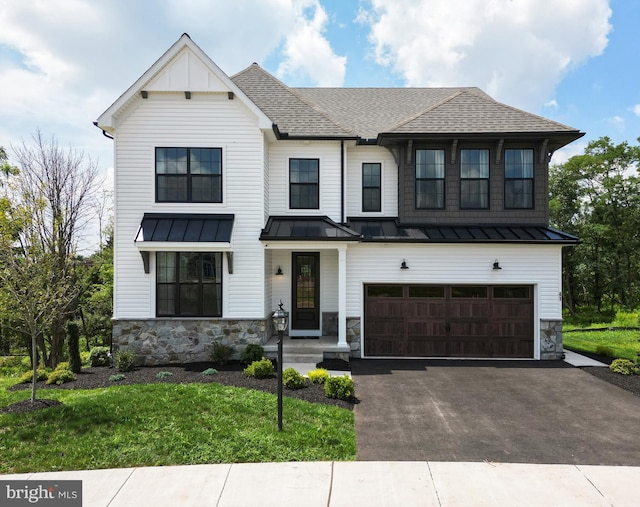 modern farmhouse style home featuring a garage and a front lawn