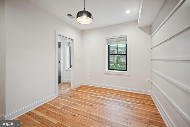 empty room featuring visible vents, recessed lighting, baseboards, and light wood-style floors