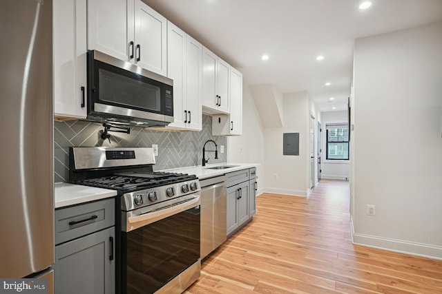 kitchen featuring white cabinets, sink, appliances with stainless steel finishes, and gray cabinets