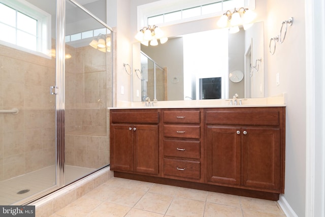 bathroom featuring double sink vanity, walk in shower, and tile patterned flooring