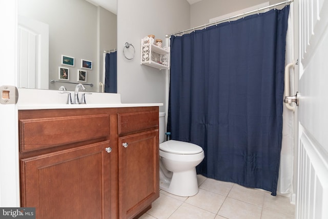 bathroom with vanity, toilet, and tile patterned flooring