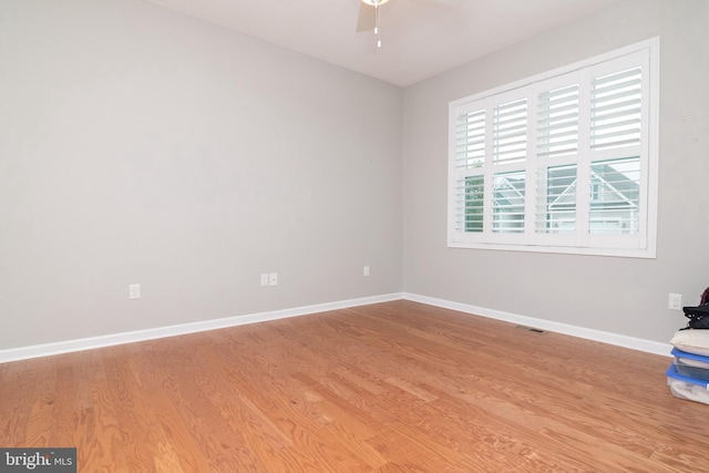 empty room with light wood-type flooring and ceiling fan