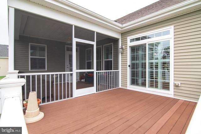 wooden deck featuring a sunroom